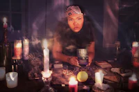 a woman holding a candle in front of candles
